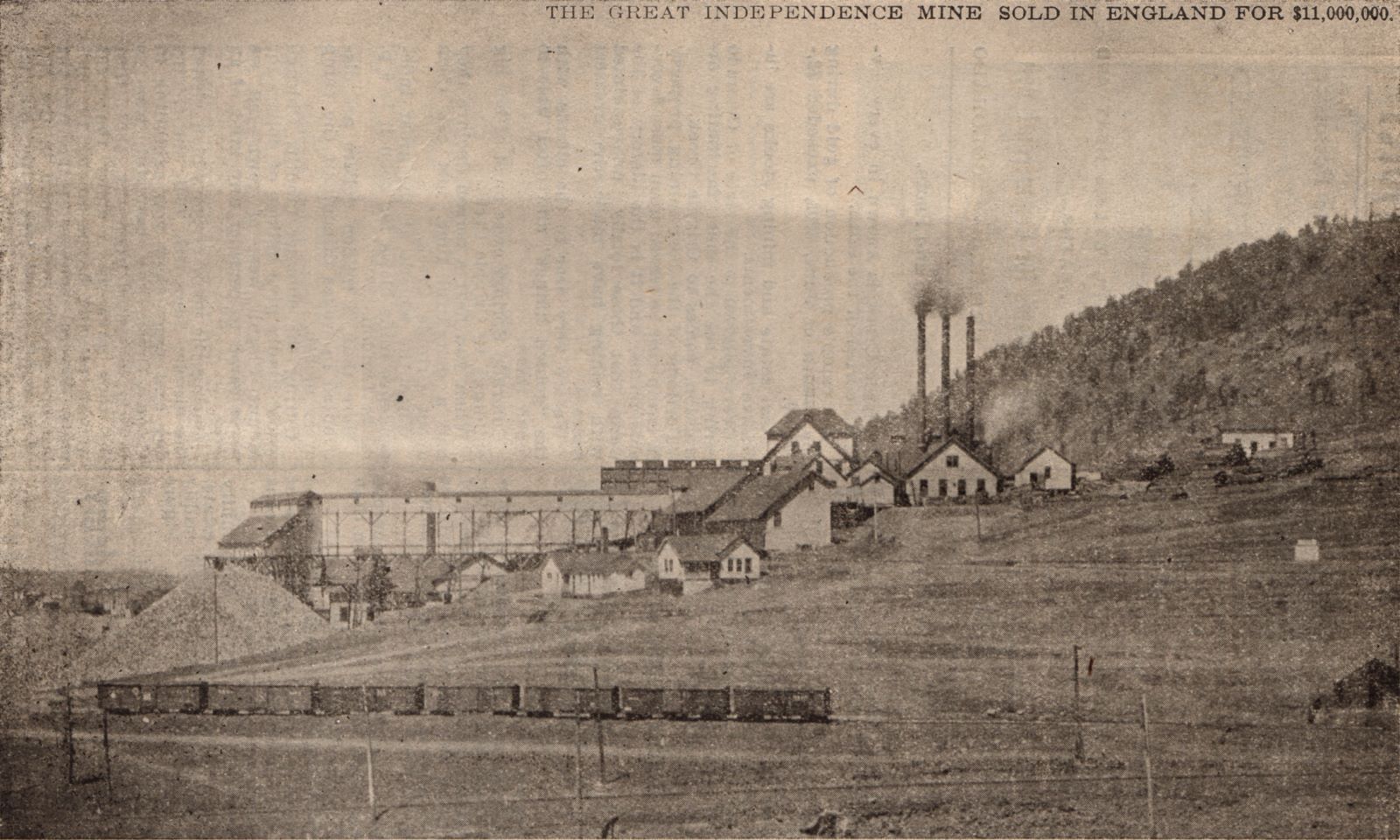This long distance shot of the large complex known as the Independence Mine is taking looking west with Squaw Mountain background right. In the foreground bottom is the trackage of the Golden Circle with a large string of boxcars set out on a spur. About 1/3 from bottom and from right towards left is the location of the Midland Terminal trackage that was later connected with the Short Line trackage that might be running at the bottom of this view, outside the view I would then presume.
   There is many structures and ore-houses at this mine, the one furthest to the left, attached with a long-covered trestle, was also an experimental mill I think.