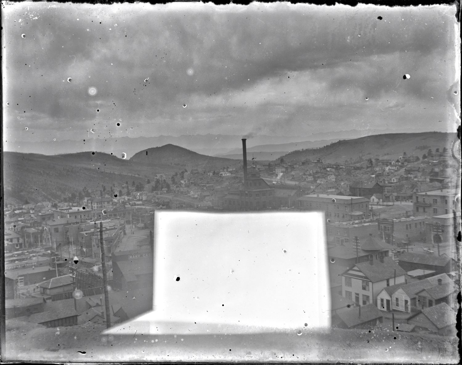 Sadly, this image is pretty messed up by that large whitish block showing up on the glass plate negative. Add the fact it is really not that sharp either, and blurs a little on the edges, and it folds itself nicely into most other images in my collection, close but not the best of views, like most of the images I have!
* Around center of the view is the familiar look of the Gold Coin structures, looking at the north and east walls.
* Near lower left is the F. & C.C. depot, the western part of it obscured by the crib-wall of the Mary Cashen mine. The Ore-house is partly hidden under the damaged part, same with the head frame, and any other possible good things.
* The M.T. depot is seen near the lower right corner.
* Near the right-hand side, about 2/5 down from the top, is the head frame and hoist house of the Golconda mine, sadly I was not able to get a sharp scan so there is no reason to try get a closer look as it really is not much to look at, not sharp at all in a higher resolution scan.