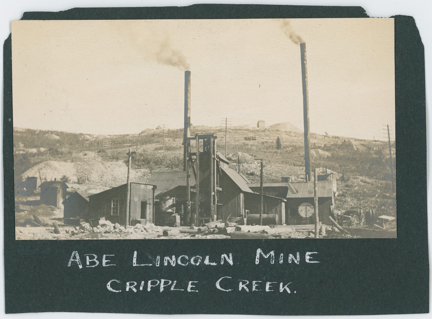 Sadly, being of type Snapshot this image is not the best one around in terms of quality such as sharpness and bring forward what hides in the more darker parts of the image, but the overall scene is quite a nice one, and a workable look at the Surface Structures of the Abe Lincoln Mine in Poverty Gulch with Gold Hill in the background.
   I do not see any signs of the Short Line Roadbed, but I do see a Trolley high up on the high Line, I think it is coming down the line, but the image quality is not good enough to find the Trolley roof pole and see where it is raised up to the wire to tell for sure the direction. But, this helps date this image to be from sometime between January 3, 1898 (when regular Trolley Service to Victor started) and middle of September 1903 when the Original High Line section of the track where the Trolley is located was closed/abandoned. 

