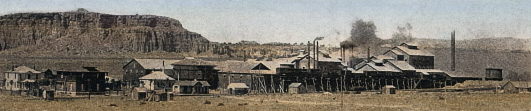 The works of the Metallic Extraction Co., the Bi-Metallic or just Metallic Mill, was situated at Cyanide, Colorado. A station that was on the Florence & Cripple Creek Railway, about 35 miles from the Cripple Creek District mines and two miles from Florence. Back in 1898 this was the oil center of Colorado, and hence was looked at as an ideal location as that part of the valley of the Arkansas had cheap and abundant  supply of coal and oil, and labor was plentiful.
   The works was erected on a flat site, following the opinion of Philip Argall that a flat site is preferable to a slope or terrace, since on the former works can be laid out not only to the best advantage but also can be operated at less expense. Ore from the Cripple Creek mines was delivered by the railway company on a double-track trestle that was at the two sampling works in use at this mill 20 ft. above the floor line of the works.
   View shows a mill work that covered quite a large site, where the mainline of the F. & C.C. ran in the foreground and the before mentioned trestle can be seen on the right half part of the image, about 1/3 up from bottom.
   I did procure the colored version of this image. Source was gray-toned, or in common speech black & white. Used an online service and tweaked and worked with image to get what looks best to my eyes for the moment.