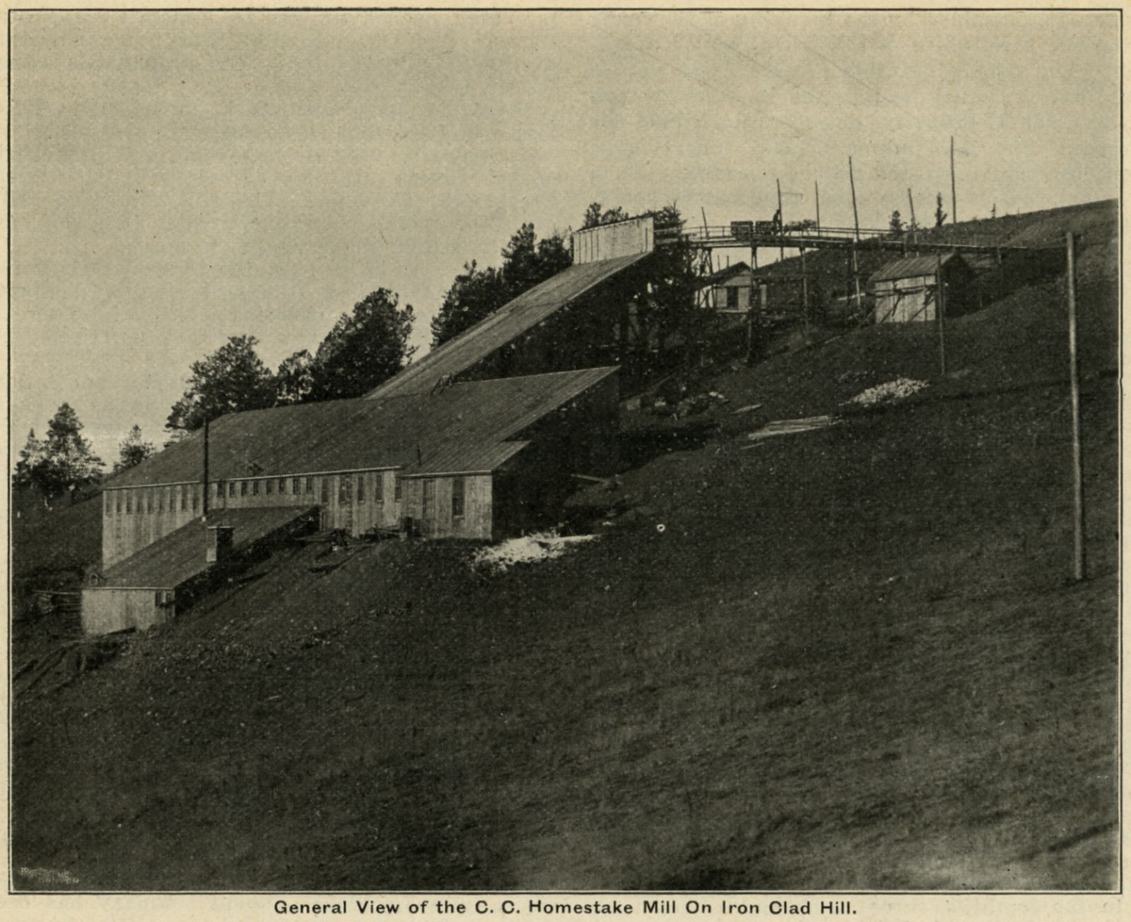 As this image is used in an April 1904 article it can't be younger than March 1904, more likely somewhat older than that, possible I would guess up to at least a year older, hard to tell, nothing in the view to date it from. Though, I have seen from a different source an image from about opposite direction, taken from someplace up on the hill about 1/3 inn from the right-hand side, showing part of this mill and said to be dated 1903 where there is a larger dump out on the trestle going to the mill then it is in this view, so if that other image is correct dated that would make this image to be somewhat older.
   Not easy to keep all the mills apart, but a mill called Ironclad Mill, which I think is this one, as I think this is the first experimental Cyanide Mill done by A. H. Heller, is at least dated back to 1902 so it is a possibility this image might also be as old as 1902-ish.
   The view itself is of a darker printed quality type so not a good one, showing a large sloped mill structure, which precise location as to which claim(s) it is built upon is not given in the text that came with the image, so I can't fully locate where it was in terms of what else can be seen in this view. I know the original High Line passed this location and I see two pieces of line side trolley poles along the ridge at upper right, which I think is part of the original High Line climbing south slopes of Globe and Ironclad Hills. And out of that, this mill is most likely on the Quartzite claim, possible into the Annex claim as well. Doubt that there are any maps to settle this issue, but maybe I one day will find it out.
   In terms of naming this mill, the source text uses the words Homestake Mill, but on Sanborn 1908 (sheet 26 for Cripple Creek) it is called Ironclad Mill while a newer mill is named Homestake, that newer mill is located more where the photographer was standing in this view here.
   I did procure the colored version of this image, if that is what you see. Source was gray-toned, or in common speech black & white. Used an online service and tweaked and worked with image to get what looks best to my eyes at the moment.