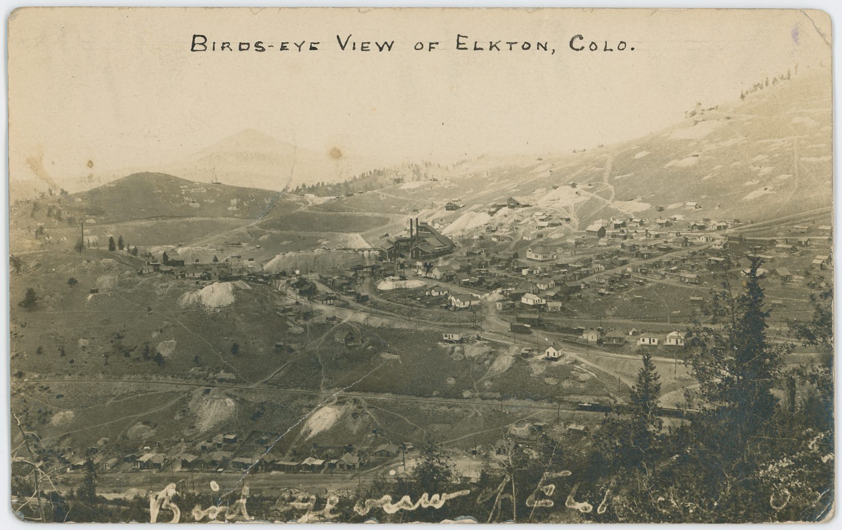 While the image quality is not that great due to the age and distance and all that, it still is a very important image to have! I struggle a little dating it as while it has a post stamp of 1908, I am unable to find the switchback from the M.T. up to the coal bins of Elkton Mine, which is shown on a USGS topographic map dated 1902/1903, which together with the showing of the Low Line which dates this after 1900, should narrow the timeframe down quite much, but the Elkton Mine structures gives me the impression this is way later then near 1900.
   This due to the fact Sanborn 1900 (CC Sheet 17) shows a different structure here, while photo matches better with Sanborn 1908 map (CC Sheet 30). But then again, that later map fails to show some of the mine structures seen here so that suggest this view predates it. And as my USGS map show a spur not here I must admit that this is from a timeframe of less than 3-years. More research is needed.
   Near bottom of this view lays a row of houses which forms the upper part of the settlement know as Eclipse, along Eclipse Gulch, stretching from about where F. & C.C. crosses the gulch and to around where the Economic Mill was further down the gulch at left, as far as I know.
   The grade of the F. & C.C. is seen about 1/4 up from the bottom, with a passenger train near right-hand side, heading towards Cripple Creek. There are several mine operations seen below and above that grade, but my knowledge is way too limited to tell anything about any of them.
   The town of Elkton is seen on the lower slope of Raven hill in the right-most half of the photo around middle of view top/down, where the large Elkton Mine makes up about center of this card, with the railroad grade of the M.T. running just left of the mine.
   The Low Line is seen about 1/3 up from bottom near right-hand side, climbing the hill towards left and about middle top/down and about 1/3 in from left-hand side it changes directions and goes towards right, cross over the M.T. on trestle and passes the Elkton mine on the right side.
   The Thompson large Shaft House (I think) is seen about center of view top/down and about 1/5 in from left-hand side, sadly I don't know of any Sanborn map of this structure, not that I can recall at the time of this writing [08.08.2017].
   There is also another mine structure at right foreground of the Thompson, left of the Low Line grade, but I dare not guestimate a name for that mine, nor do I dare take a stab at the name of the ones seen inside the town of Elkton either. One is easy to spot, just right of the mainline of M.T. with a large dump area, the other is more hidden among houses, still with a dump though. One day I hope to learn all this, one day.
   Raven Hill has it shares of mines as well, but the one I sort of care about is the Bostwick Shaft House, seen about 1/3 down from top and slightly right of center of view sideways, up from right-hand side of the Elkton mine.