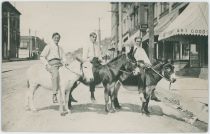 A View at 3 Men on Donkeys Along Victor Avenue in Victor, Looking West